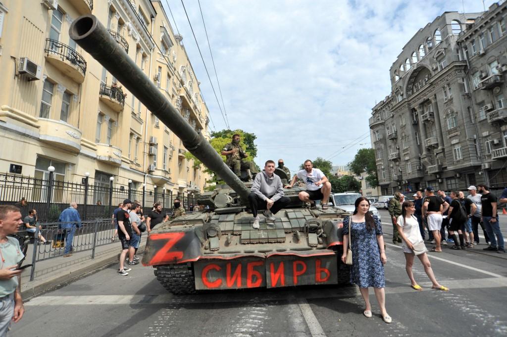 Des habitants de Rostov-sur-le-Don se tiennent près des véhicules blindés du groupe Wagner. [AFP - Arkady Budnitsky / Anadolu Agency]