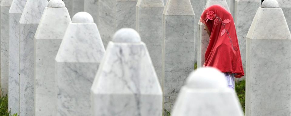 Une jeune musulmane bosniaque se recueille au mémorial de Potocari lors des funérailles de 175 musulmans bosniaques nouvellement identifiés à Srebrenica, en Bosnie-Herzégovine, le 11 juillet 2014. [Keystone/EPA - Fehim Demir]