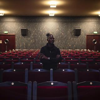 Abou Sangare, lead actor in "Souleymane's Story," poses for photographs after a premiere at the Louxor cinema in Paris, Tuesday, Oct. 8, 2024. [AP Photo/Keystone - Louise Delmotte]