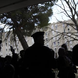 Police officers stand guard as French President Emmanuel Macron pays a visit focusing on security and the fight against drug trafficking, Tuesday, March 19, 2024 in La Castellane district of Marseille, southern France. [AP Photo/Keystone - Christophe Ena, Pool]