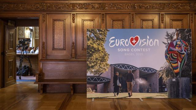 A poster with the Eurovision Song Contest (ESC) logo stands in the town hall as the press conference on the staging of the ESC 2025 takes place, in Basel, on Friday, August 30, 2024. The ESC 2025 will be held in Basel. This was announced today by the SRG. (KEYSTONE/Georgios Kefalas) [Keystone - Georgios Kefalas]