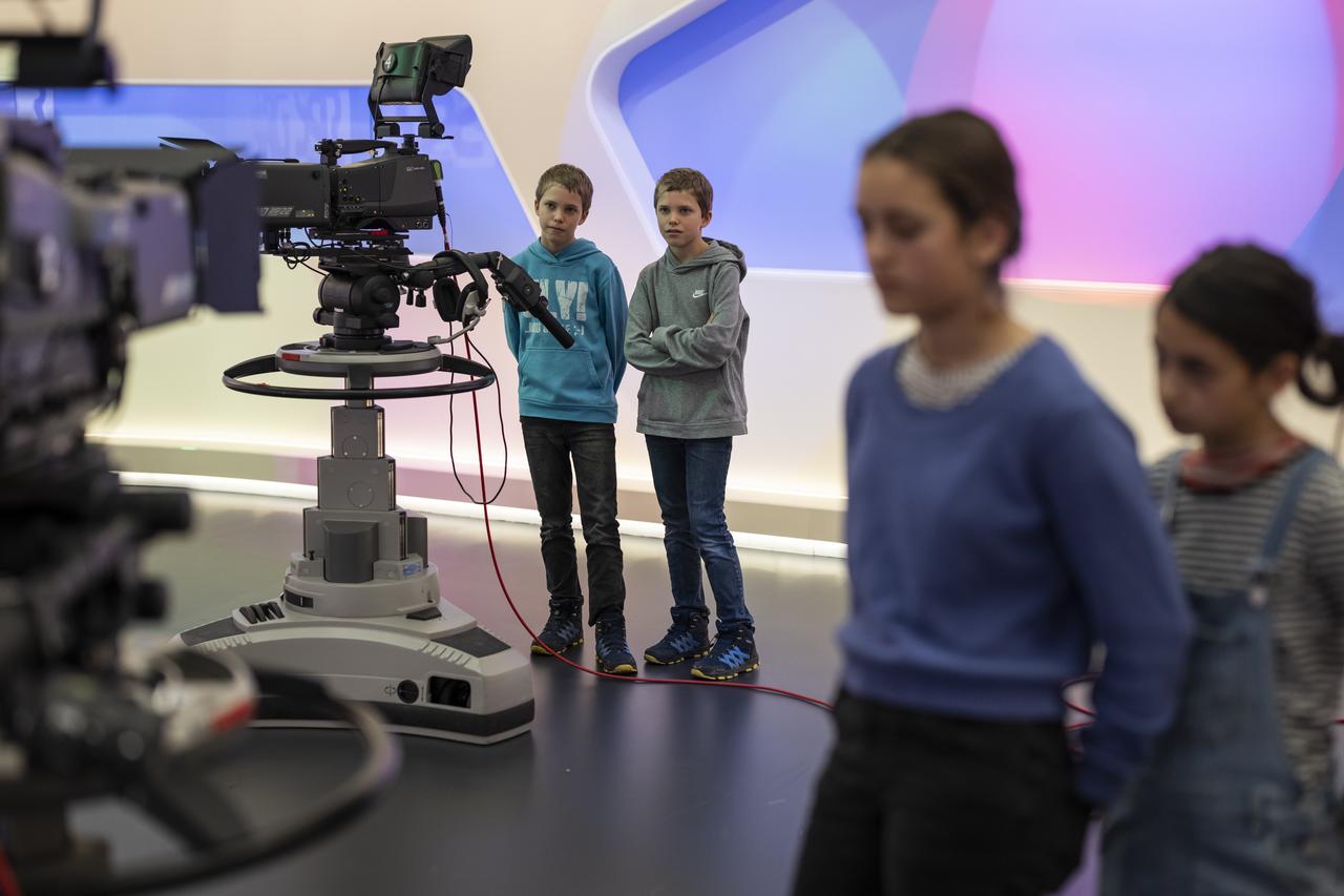 Des enfants visitent le studio TV de la SSR au Centre des médias du Palais fédéral à Berne, dans le cadre de leur visite à l'agence de presse Keystone-ATS, lors de la journée nationale "Futur en tous genres". [KEYSTONE - ALESSANDRO DELLA VALLE]