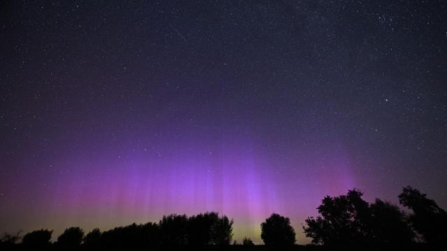 Vue du ciel nocturne lorsque l'interaction entre le champ magnétique terrestre et les particules solaires provoque des aurores boréales. District de Brandenburg, Allemagne, le 13 août 2024. [Anadolu via AFP - Omer Sercan Karkus]