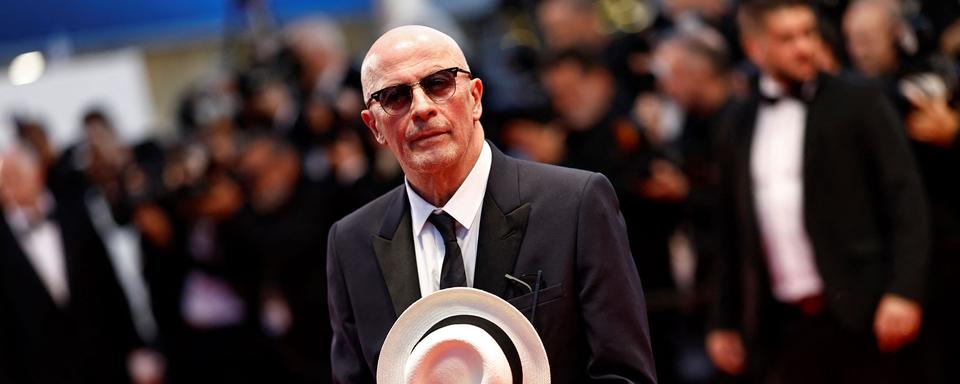 Le réalisateur français Jacques Audiard sur le tapis rouge pour son film "Emilia Perez" le 18 mai 2024 à Cannes. [AFP - Sameer Al-Doumy]