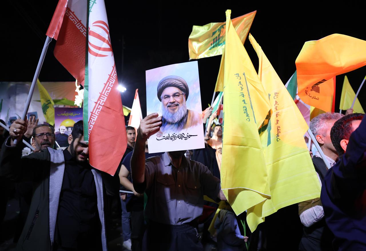 Dans les rues de Téhéran, la population s'est réjouie de l'attaque de missiles menée contre Israël avec des drapeaux du Hezbollah et des posters de son leader Hassan Nasrallah. [KEYSTONE - ABEDIN TAHERKENAREH]