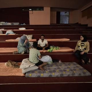 Une famille de réfugiés, à Beyrouth au Liban. [Keystone - AP Photo/Hussein Malla]