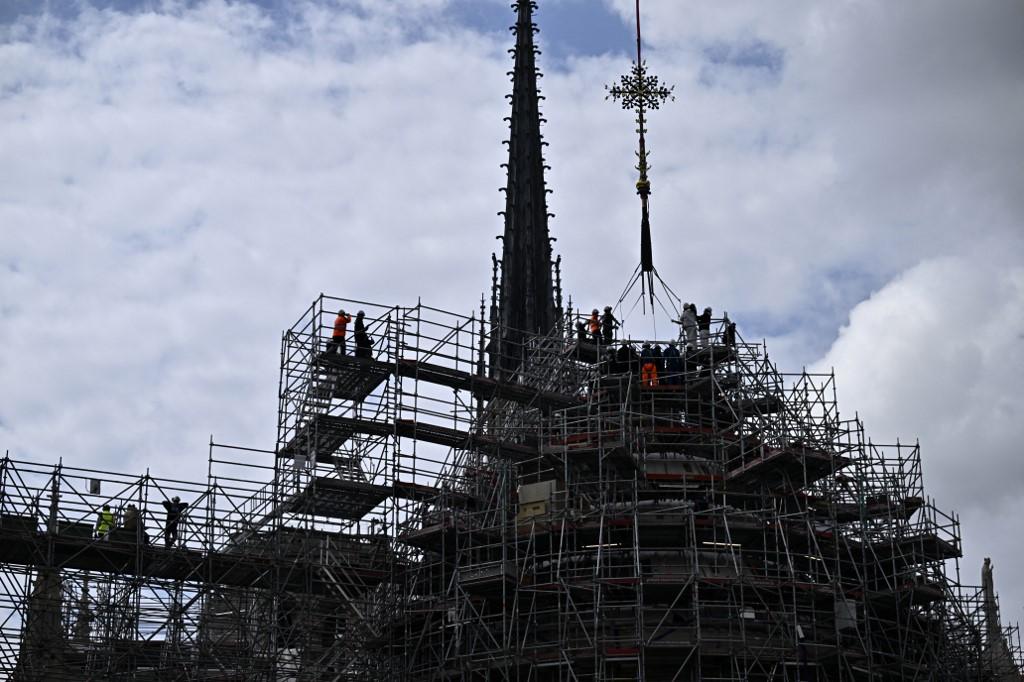 La croix du chevet de Notre-Dame de Paris a été réinstallée au sommet de la charpente, le 24 mai 2024. [AFP - JULIEN DE ROSA]