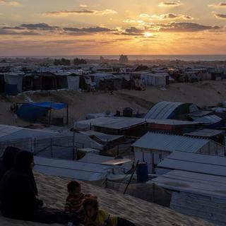 Displaced Palestinians, who fled their homes due to Israeli airstrikes and evacuation orders, sit next to their tents at a makeshift camp in Khan Yunis camp, southern Gaza Strip, 07 October 2024. According to the UN, at least 1.9 million people (or nine in ten people) across the Gaza Strip are internally displaced, including people who have been repeatedly displaced. Since October 2023, only about 11 percent of the Gaza Strip has not been placed under Israeli-issued evacuation orders, the UN aid coordination office OCHA said. More than 41,900 Palestinians and over 1,400 Israelis have been killed, according to the Palestinian Health Ministry and the Israel Defense Forces (IDF), since Hamas militants launched an attack against Israel from the Gaza Strip on 07 October 2023, and the Israeli operations in Gaza and the West Bank which followed it. [EPA/Keystone - HAITHAM IMAD]