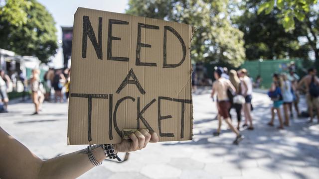 Une personne cherche un ticket pour un festival. [Keystone - Peter Klaunzer]