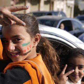 Des enfants réfugiés sur le chemin du retour du Liban à la Syrie. [Keystone/AP Photo - Hassan Ammar]