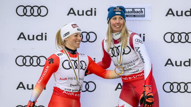 Lara Gut-Behrami tout sourire aux côtés de Cornelia Hütter, lauréate du globe de la descente. [Keystone - Gian Ehrenzeller]