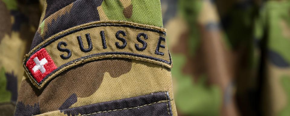 Le logo de l'armée suisse sur la tenue de camouflage de l'armée suisse. [KEYSTONE - Laurent Gillieron]