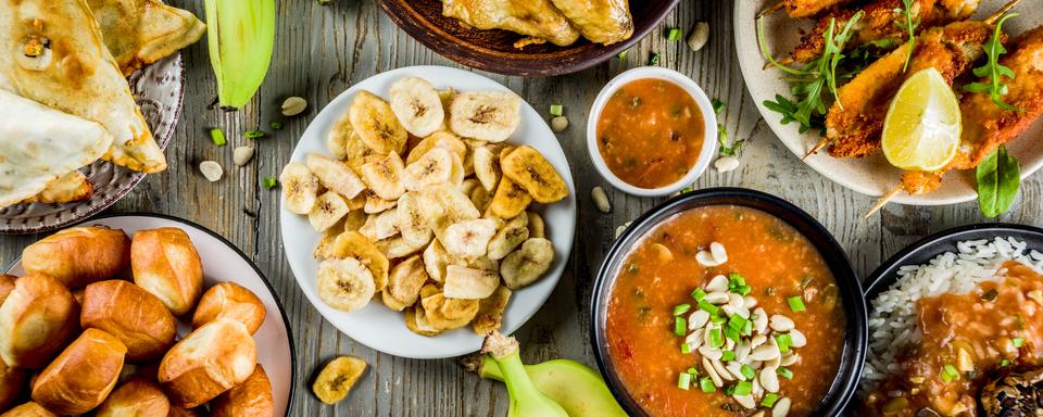 Un assortiment de plats d'Afrique de l'Ouest: soupe de cacahuètes, riz jollof, ailes de poulet grillées, bananes plantain frites, kebab de poulet nigérian et tartes à la viande. [Depositphotos - unixx.0.gmail.com]