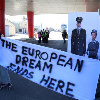 Une manifestation ironise sur le transfert forcé dans des camps albanais des migrants qui sont arrivés en Italie. [Keystone/EPA - Malton Dibra]