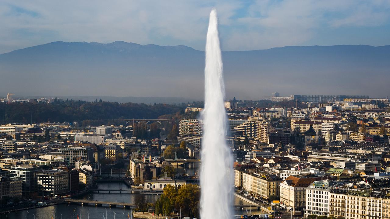 Le jet d'eau de Genève et la ville en arrière-plan. [Keystone - Valentin Flauraud]