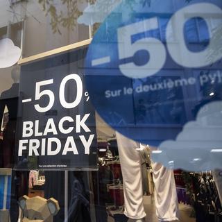 Une affiche dans une vitrine en vue de la journée de soldes du Black Friday. [Keystone - Cyril Zingaro]