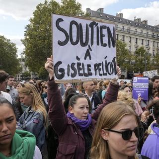 People take part in a gathering in support of 71-year-old Gisele Pelicot who was allegedly drugged by her ex-husband and raped by dozens of men while unconscious, Saturday, Sept. 14, 2024 in Paris. Placard reads, "support for Gisle Pelicot." [AP Photo/Keystone - Michel Euler]