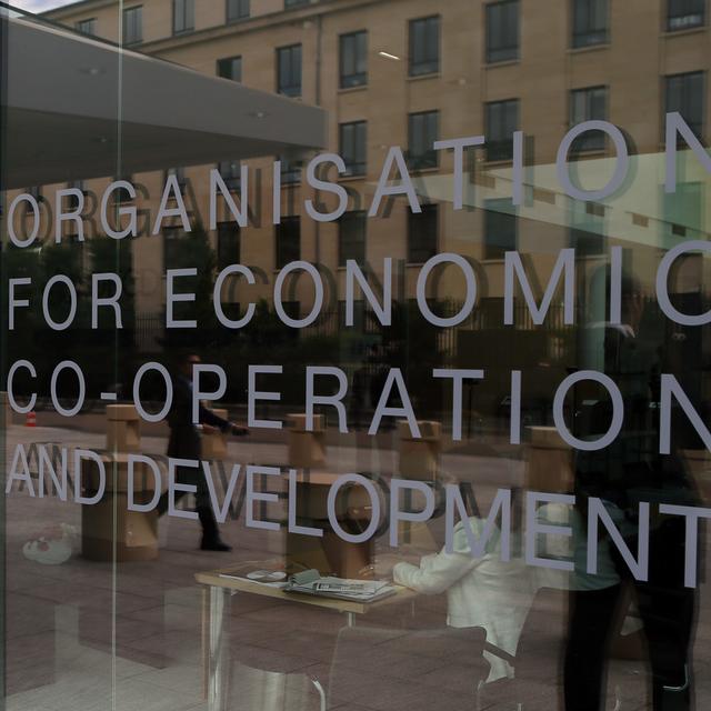 L'imposition minimale de l'OCDE est en retard en Suisse. [Keystone/AP Photo - Francois Mori]
