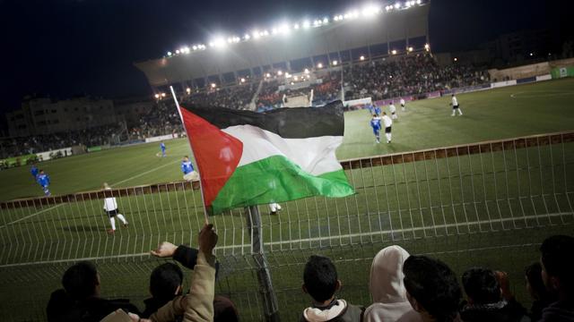 L'équipe de football palestinienne joue contre le Qatar en Coupe d'Asie des nations. [Keystone - AP Photo/Bernat Armangue]