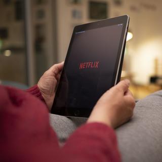 Netflix continue à gagner des millions d'abonnés. [Keystone - Christian Beutler]