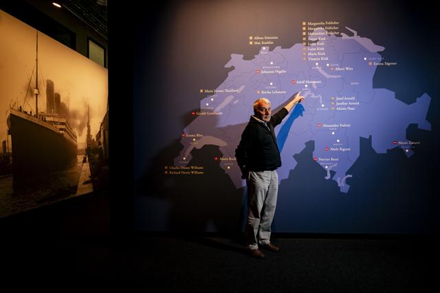 Kurt Hess, petit-fils du frère de Adolf Mattmann, suisse disparu lors du naufrage du Titanic, pose devant une carte de "Titanic L'Exposition", Beualieu-Lausanne. [KEYSTONE - JEAN-CHRISTOPHE BOTT]