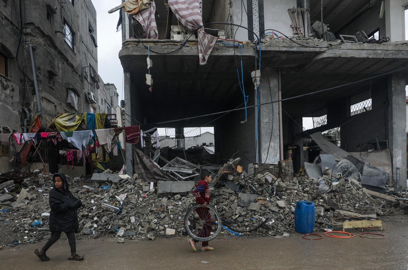 Décombres de structures détruites lors d'une opération militaire israélienne dans le camp de réfugiés d'Al Nusairat, dans le sud de la bande de Gaza, le 19 février 2024. [KEYSTONE - MOHAMMED SABER]