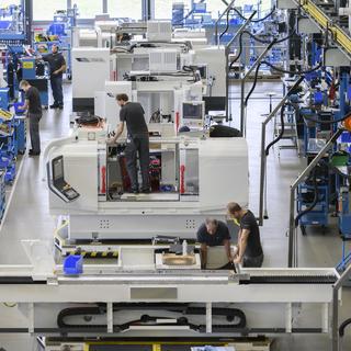 Des employés du constructeur de machines Fritz Studer AG photographiés dans le hall de production de Steffisburg, dans le canton de Berne, le 19 avril 2019 (image d'illustration). [keystone - Christian Beutler]