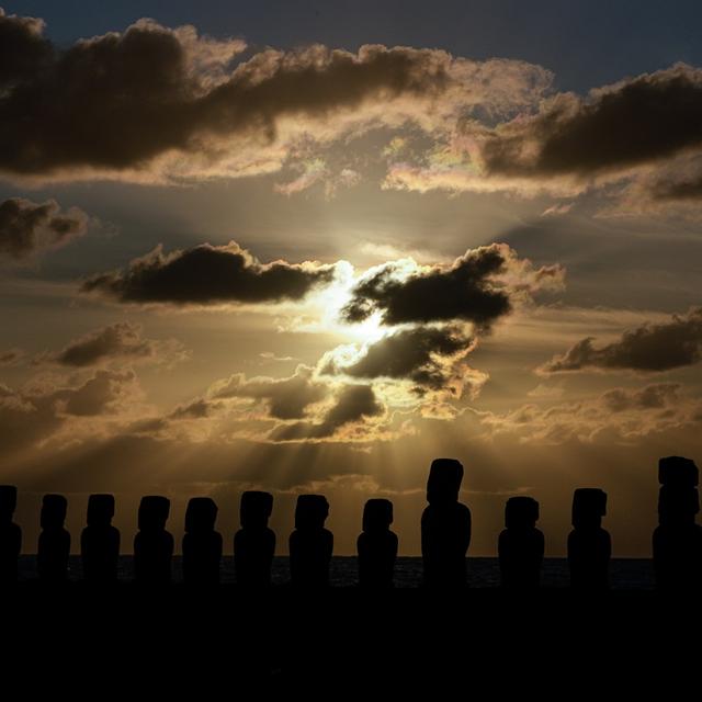 The sun rises behind moais statues on Ahu Tongariki, Rapa Nui, or Easter Island, early Thursday, Oct. 3, 2024. Each monolithic human figure carved centuries ago by this remote Pacific island's Rapanui people represents an ancestor. [AP Photo/Keystone - Esteban Felix]