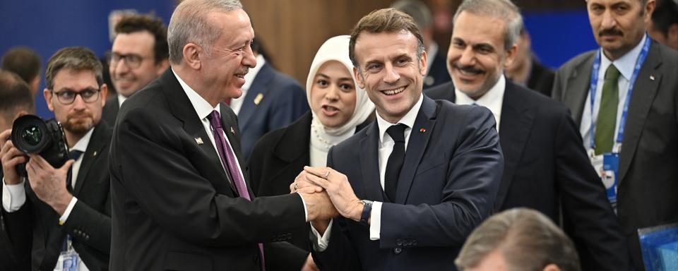 Emmanuel Macron et Recep Tayyip Erdogan se serrent la main au sommet de la Communauté politique européenne. [AP Photo / Keystone - Denes Erdos]