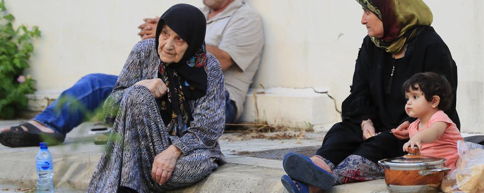 Deux femmes, un enfant et un homme de la ville de Sidon se préparant à fuir les tirs d'Israël au Liban. [Keystone/AP Photo - Mohammed Zaatari]