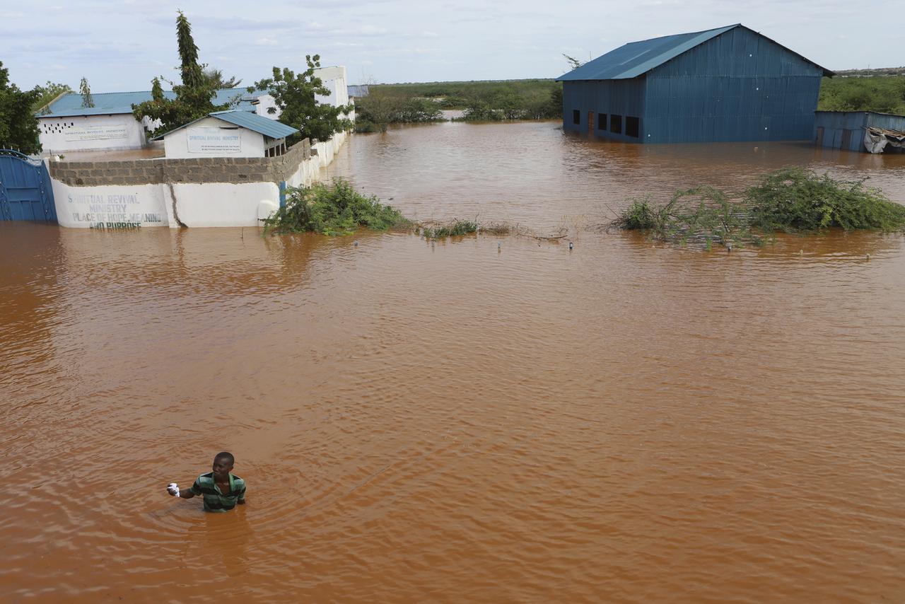 Un homme près d'une église inondée par le débordement de la rivière Tana, dans le nord-est du Kenya, le 28 avril 2024. [KEYSTONE - ANDRE KASUKU]