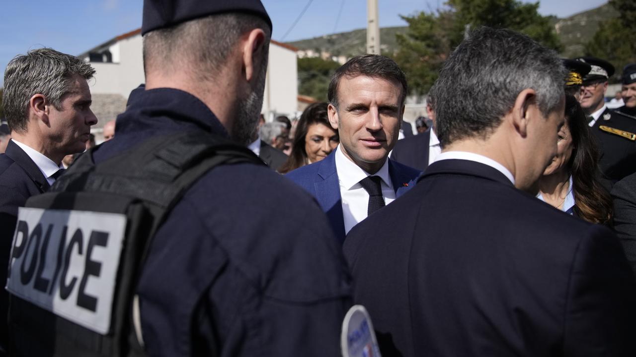 Le président français Emmanuel Macron s'entretient avec des policiers lors d'une visite axée sur la sécurité et la lutte contre le trafic de drogue, à La Castellane, quartier de Marseille, dans le sud de la France, le 19 mars 2024. [EPA/CHRISTOPHE ENA]