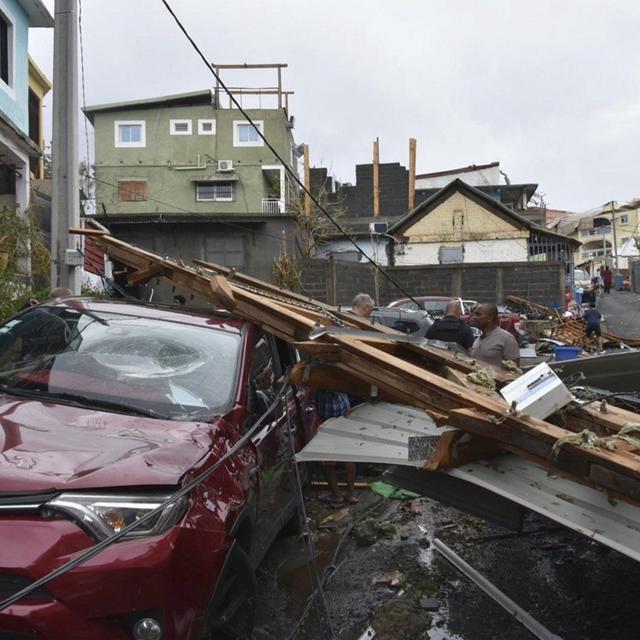 Des survivants tentant de nettoyer les rues de Mayotte, après le passage de l'ouragan Chido. 17 décembre 2024. [DICOM via AP/Keystone - Ministere de l'Interieur]