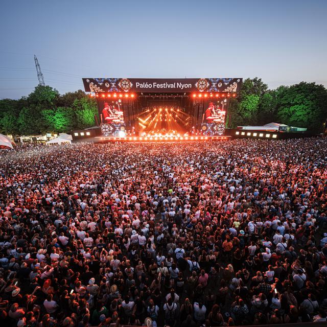 Festival goers enjoy the performance of Congolese singer and rapper Gims as he performs on the main stage during the 47th edition of the Paleo Festival in Nyon, Switzerland, Sunday, July 28, 2024. The Paleo is an open-air music festival attended by approximately 250'000 spectators over six days and takes place from July 23 to 28. (KEYSTONE/Valentin Flauraud) [Keystone - Valentin Flauraud]