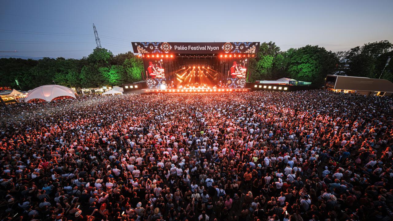 Festival goers enjoy the performance of Congolese singer and rapper Gims as he performs on the main stage during the 47th edition of the Paleo Festival in Nyon, Switzerland, Sunday, July 28, 2024. The Paleo is an open-air music festival attended by approximately 250'000 spectators over six days and takes place from July 23 to 28. (KEYSTONE/Valentin Flauraud) [Keystone - Valentin Flauraud]