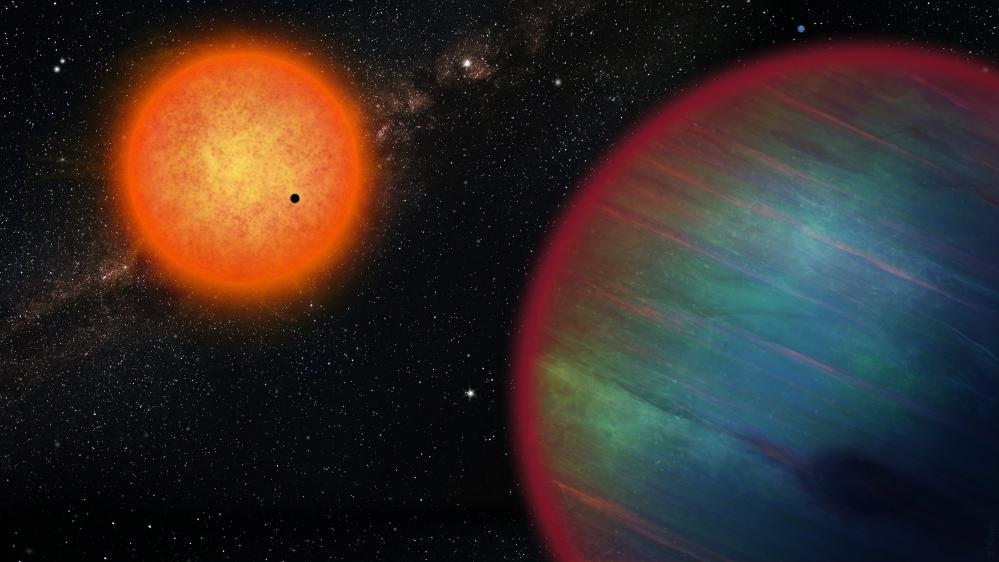 Le système WASP-132 ne contient pas seulement la Jupiter chaude WASP-132b, mais d'autres planètes dont une super-Terre, vue en train de transiter devant l'étoile-hôte orange (de type K), et une planète glacée, WASP-132d (le petit point bleu dans le coin supérieur droit). [UNIGE - Vision d'artiste par Thibaut Roger]