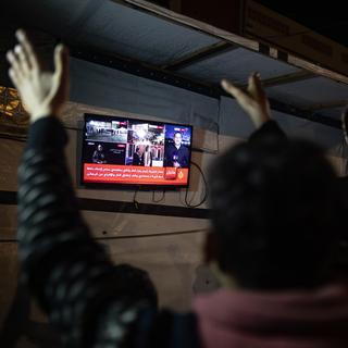 La réaction d'un Palestinien après l'annonce du cessez-le-feu. [Keystone - EPA/Haitham Imad]