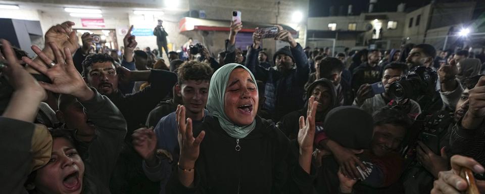 Des palestiniens célébrant la déclaration de cessez-le-feu négociée entre Israël et le Hamas. Deir-al-Balah (Bande de Gaza), le 15 janvier 2025. [AP Photo/Keystone - Abdel Kareem Hana]