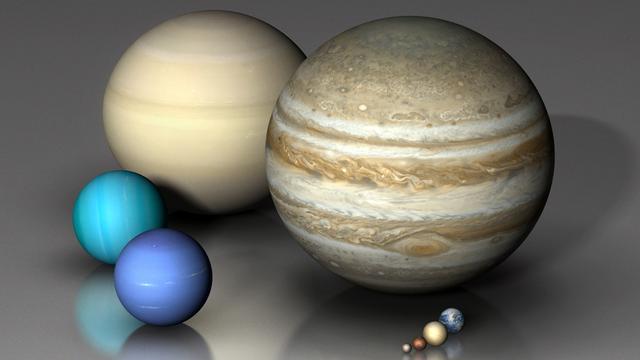 Les huit planètes du système solaire et la planète naine Pluton. [Mark Garlick / MGA / Science Photo Library]