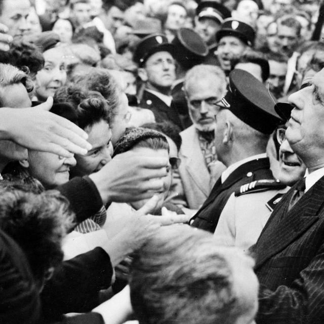 Le général de Gaulle serre de nombreuses mains à Rennes, où il vient de présenter le projet de la nouvelle Constitution et inciter les Français à voter "OUI" au référendum du 28 septembre 1958. Ce référendum donnera naissance à la Vème République.