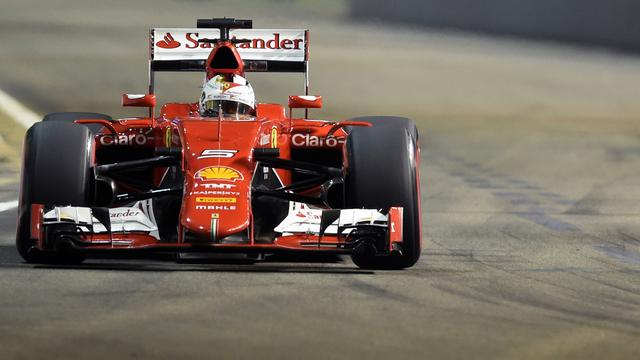 Sébastien Vettel au volant de sa Ferrari. [ROSLAN RAHMAN / AFP]