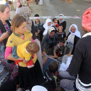 Des membres de la minorité Yézidis arrivent à la frontière entre la Syrie et l'Iraq en août 2014.
EPA STR
Keystone [Keystone - EPA STR]