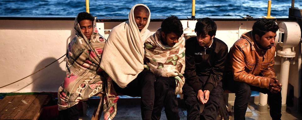 Des migrants à bord du MV Aquarius. [AFP - Louisa Gouliamaki]