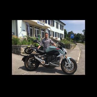Ludovic Rumo, patron du garage M&R Speedshop à Fontainemelon (NE), avec la moto électrique essayée par notre journaliste. [RTS - Jérôme Zimmermann]