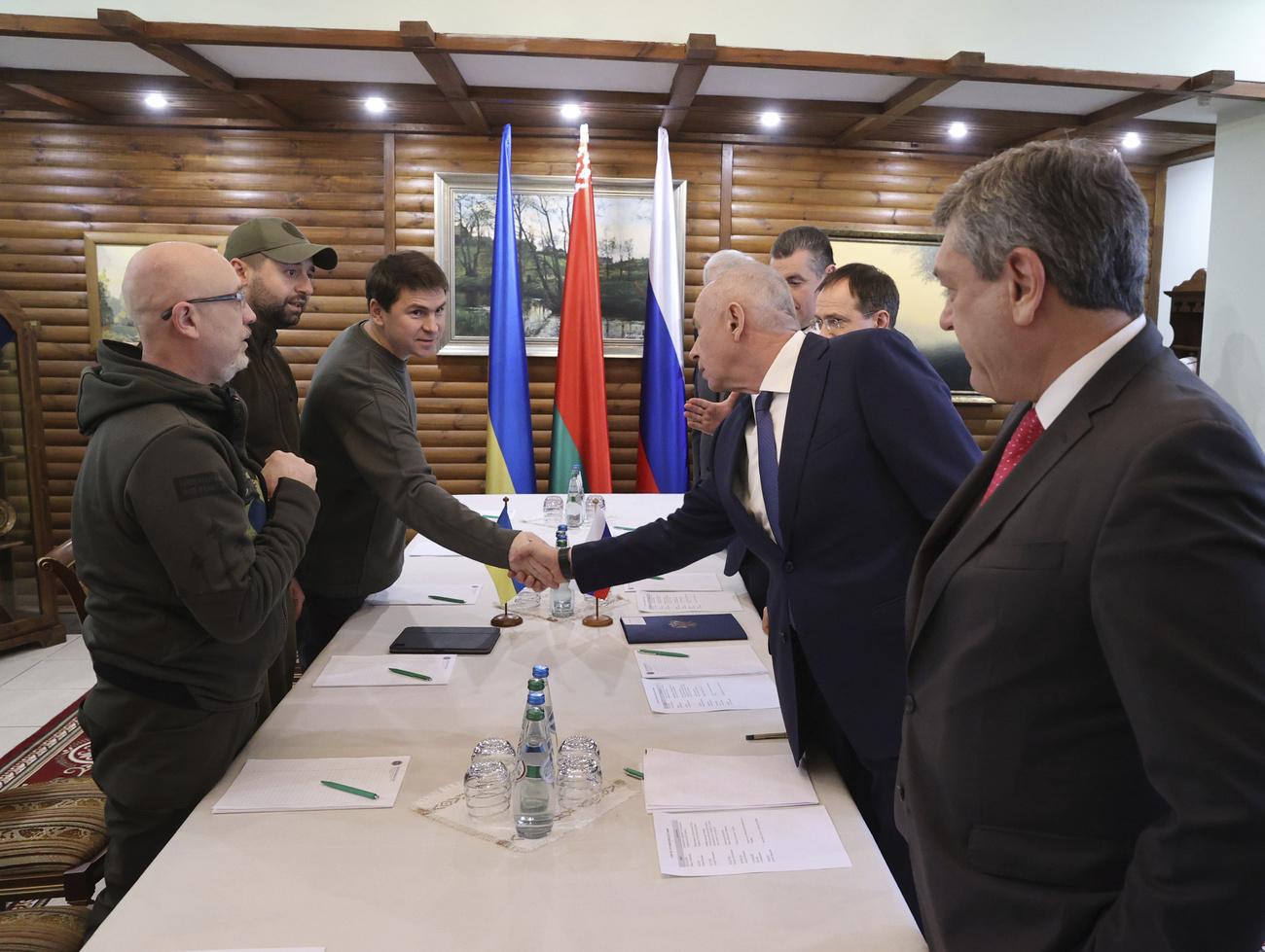 La délégation ukrainienne (à gauche) et la russe lors des pourparlers de paix organisés en Biélorussie. [BelTA Pool Photo via AP - Maxim Guchek]