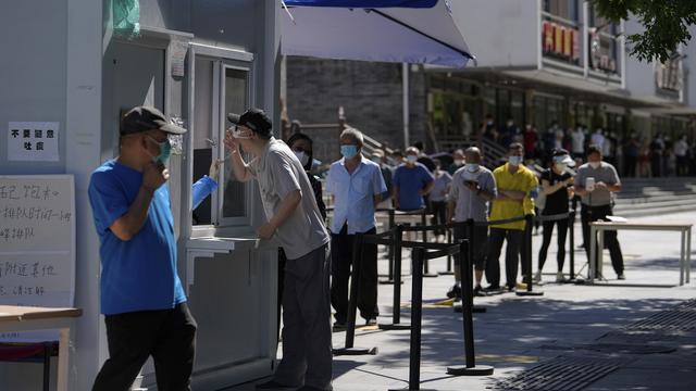 Des Pékinois font la queue pour se faire dépister pour le Covid-19. [AP Photo - Andy Wong]