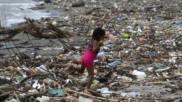 Un enfant marche au milieu des ordures sur une plage de Omoa, au Honduras [AFP - ORLANDO SIERRA]