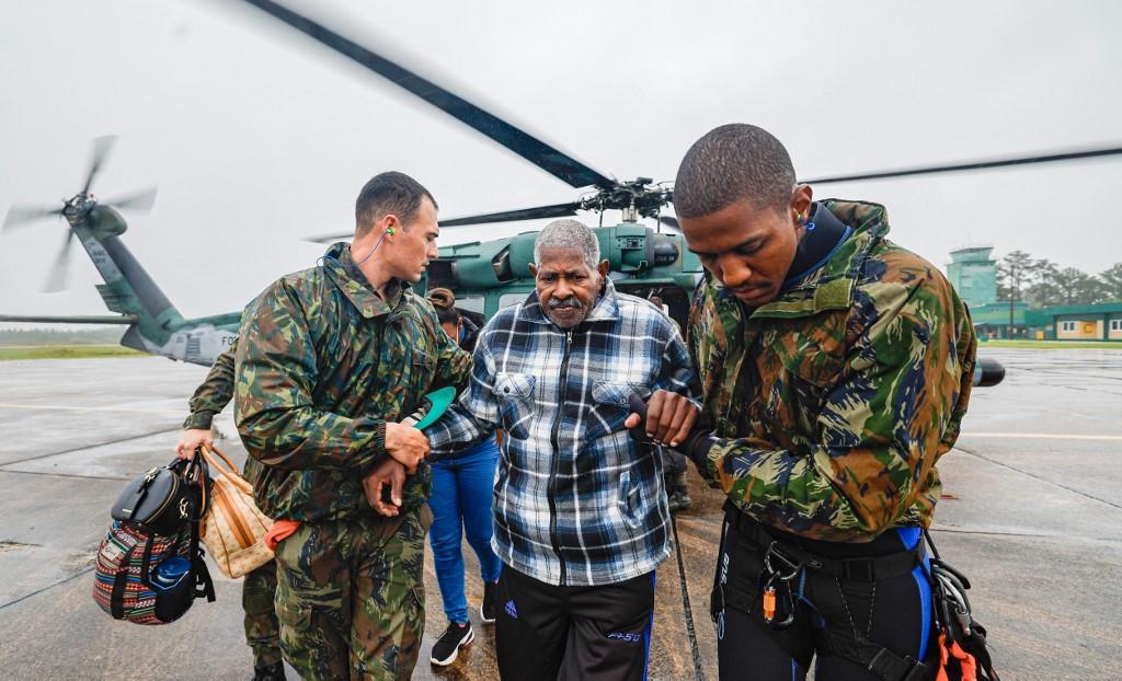 Cette photo des autorités brésiliennes montre un homme évacué par l'armée de l'air après avoir été secouru dans une zone inondée, le 2 mai 2024. [AFP / BRAZILIAN PRESIDENCY - RICARDO STUCKERT]