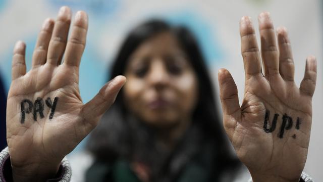 Une manifestante, photographiée en marge de la COP29 à Bakou le 23 novembre 2024, demande aux pays riches d'augmenter leur aide aux pays en développement. [AP PHOTO/KEYSTONE - RAFIQ MAQBOOL]