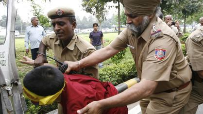 Les policiers indiens embarquent un des exilés tibétains.